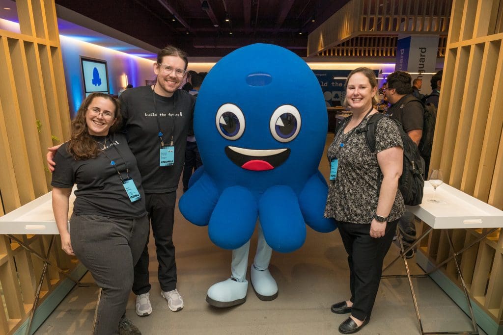 Attendees posing with Chainguard mascot Linky at Chainguard Assemble 2025, Convene San Francisco