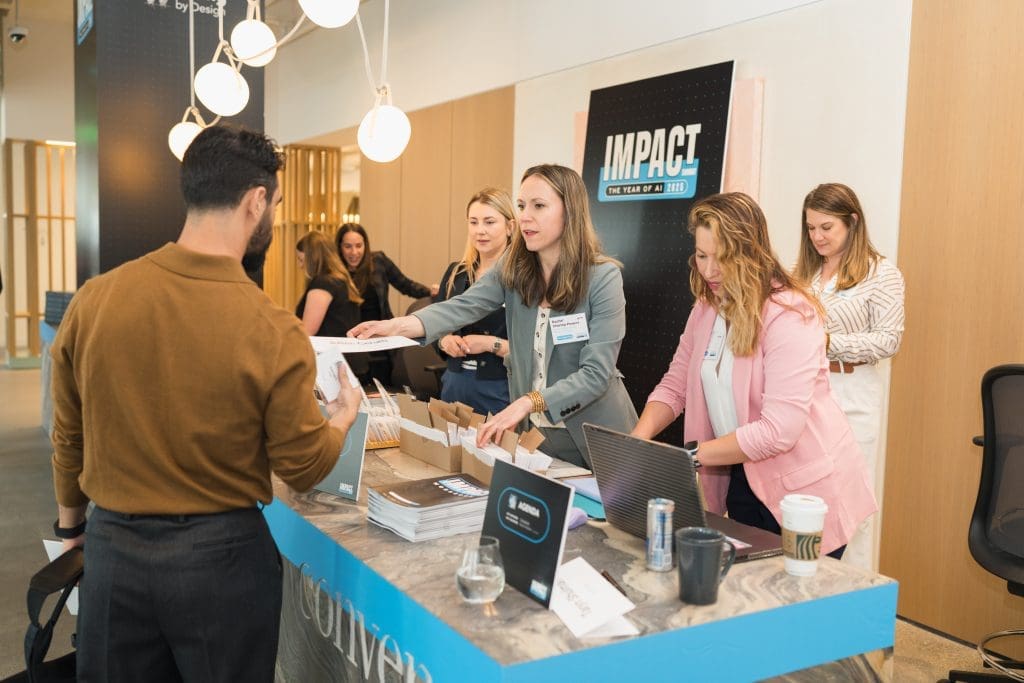 Attendee check-in at The Impact Summit 2025 registration desk, Convene San Francisco